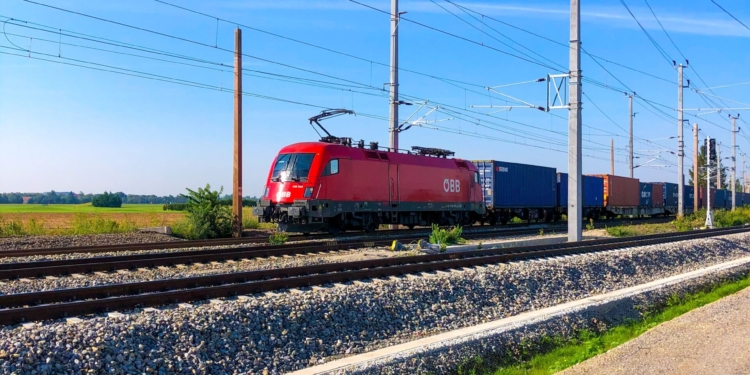 Tren de mercancías que circula por una línea ferroviaria en un entorno rural